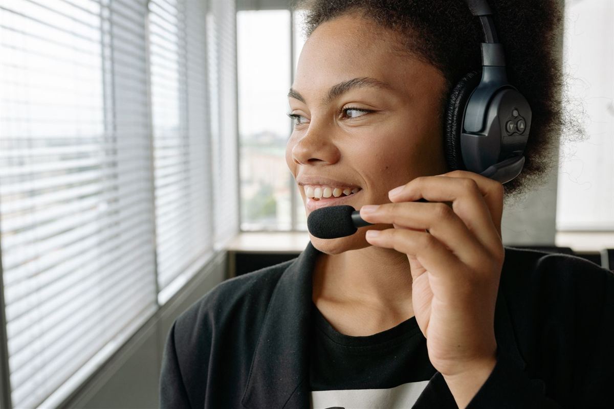 Smiling African support agent talking on a headset