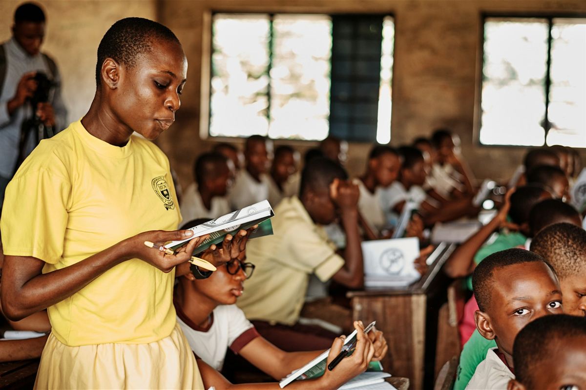 Teacher reading with pupils in a classroom