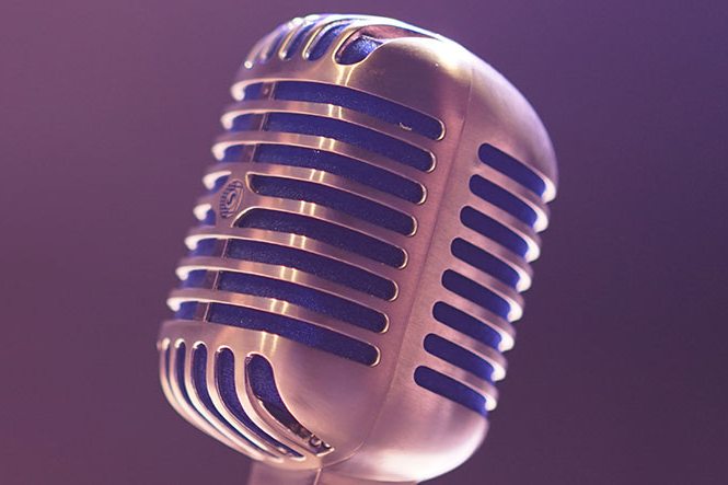 Vintage studio microphone on a purple background