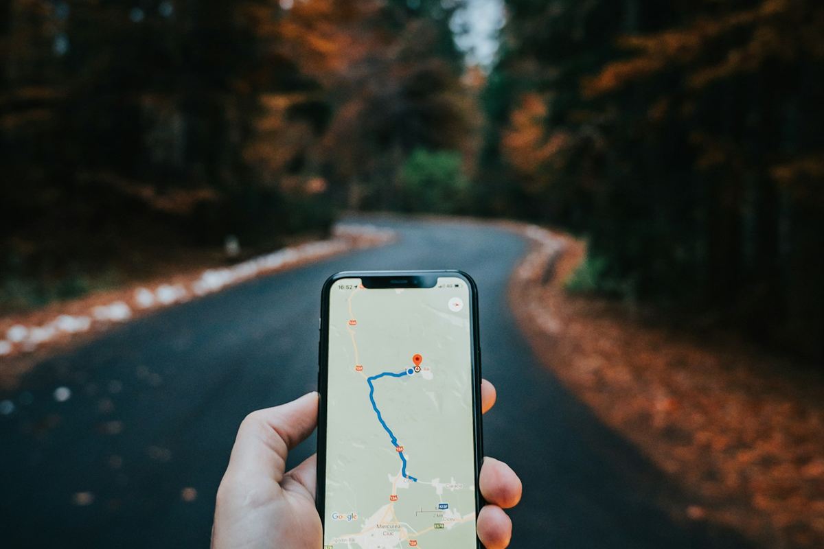 Hand holding a smartphone showing map directions