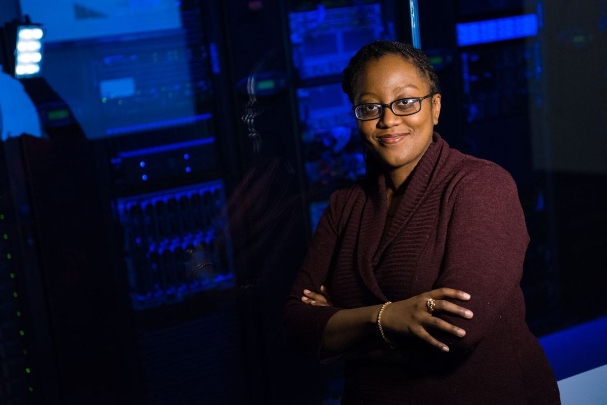 African IT manager standing confidently in a server room