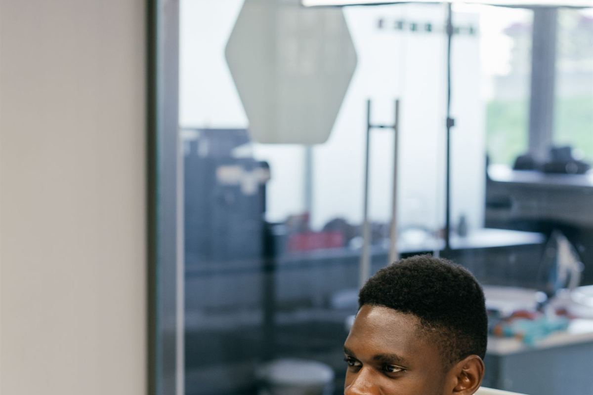 African professional working at a laptop in a modern office