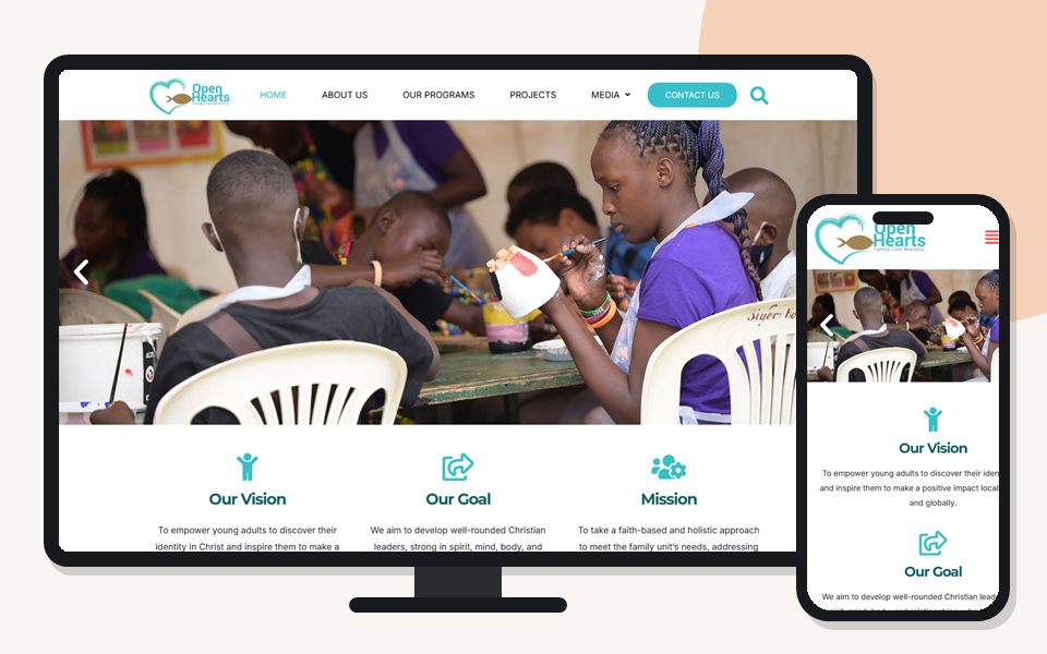 Open Hearts Family Care Ministries website shown on a desktop monitor and a mobile phone